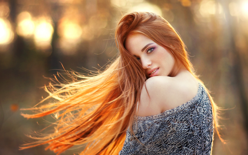 Woman with beautiful red hair outside