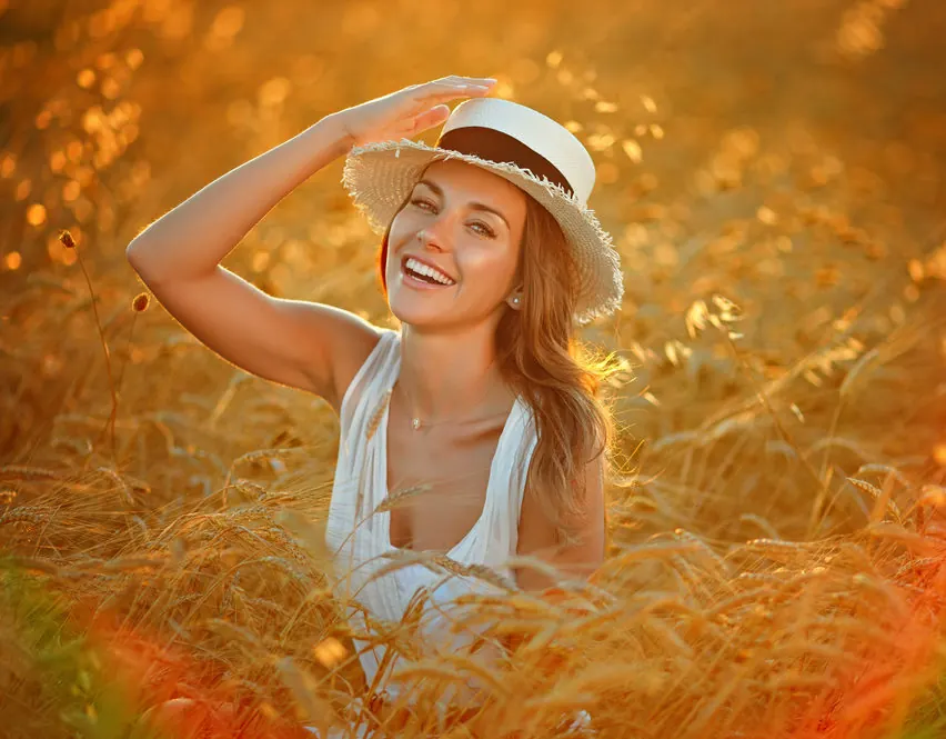 happy woman laying in a field after Aquagold treatment